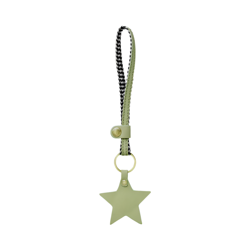 Green star-shaped leather keychain with a strap on a white background