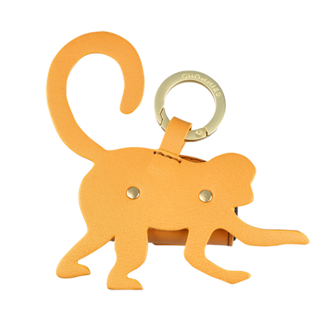 Orange monkey-shaped keychain with a gold ring on a white background